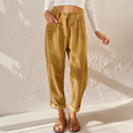 Mustard yellow high-waisted corduroy pants with front pleats, a relaxed tapered leg, and adjustable turn-up cuffs.