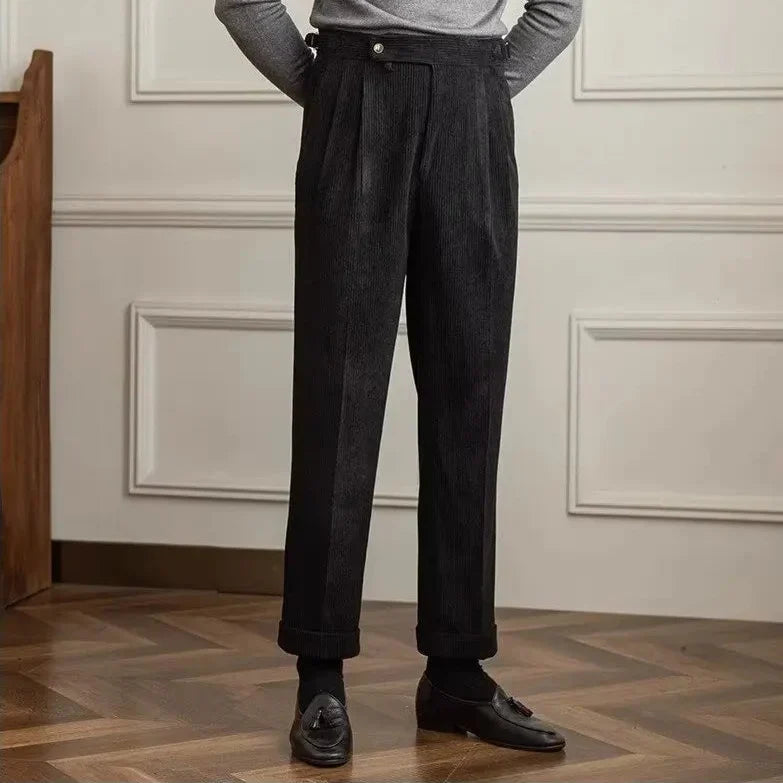 Black high-waisted pleated corduroy pants with side adjusters and turn-up cuffs
