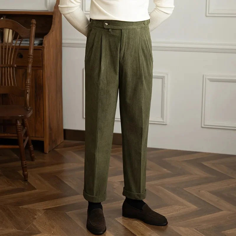 Olive green high-waisted pleated corduroy pants with side adjusters and turn-up cuffs