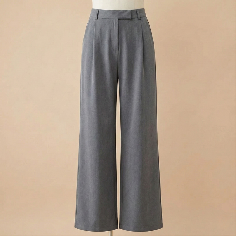 Front product view on a mannequin of gray high-waisted wide-leg wool pants featuring a pleated front, extended waistband, and pressed leg creases against a warm beige background.
