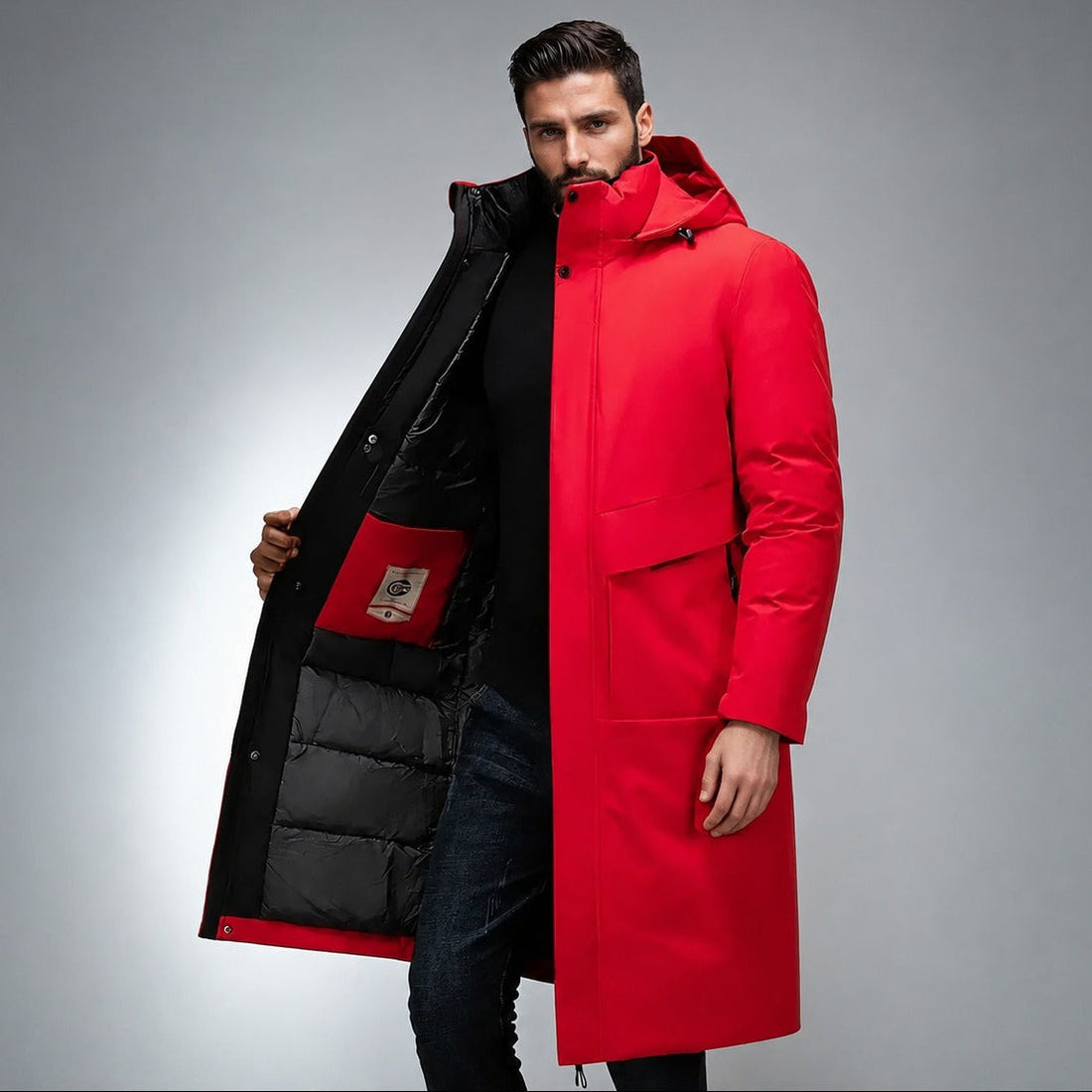Red longline parka with a matte shell, high stand collar, built-in hood, and black quilted interior lining.