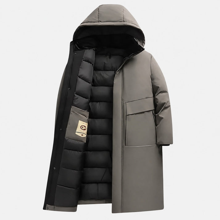 Gray longline parka with a matte shell, hooded design, and black quilted interior lining featuring deep utility pockets.