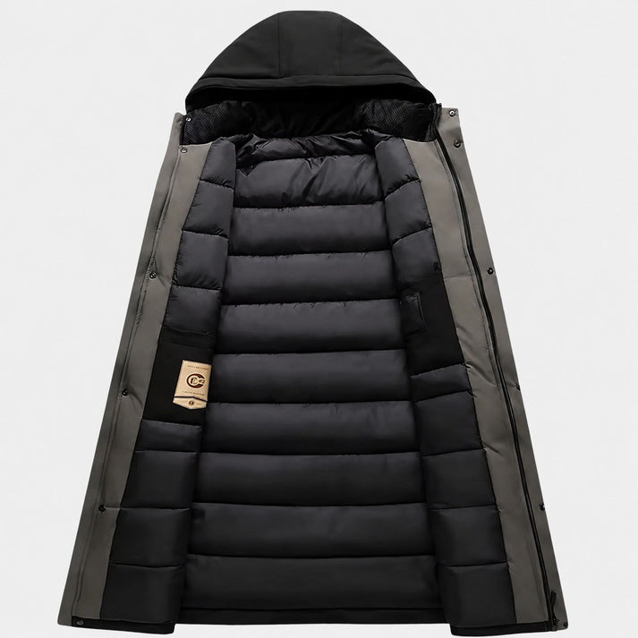 Longline parka in matte gray with a black quilted interior, featuring a built-in hood and snap storm flap closure.