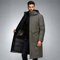 Gray longline parka with a matte shell, high stand collar, built-in hood, and black quilted interior lining.