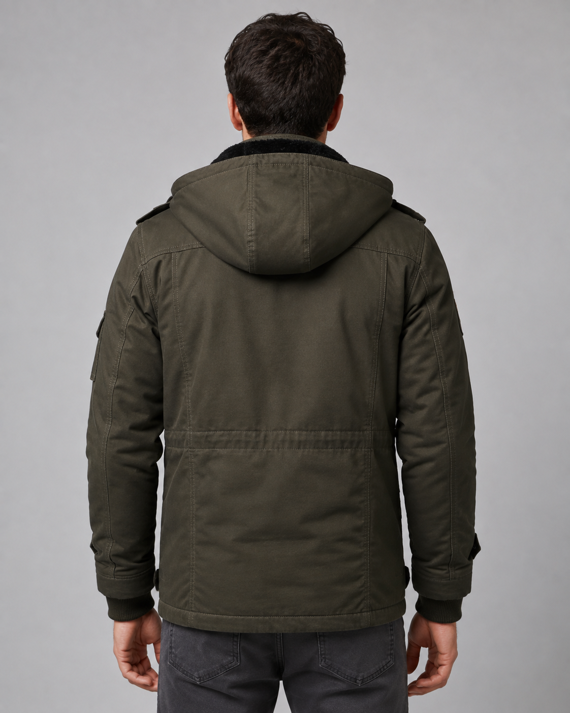 Back view of a model wearing the olive green hooded utility jacket, highlighting the fleece-lined hood and back seam details.