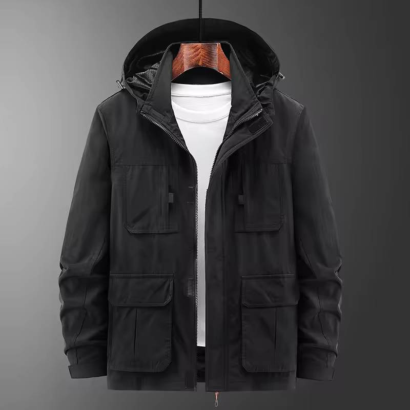Front product layout view of the black hooded utility jacket on a hanger displaying the open zipper front and four flap cargo pockets.