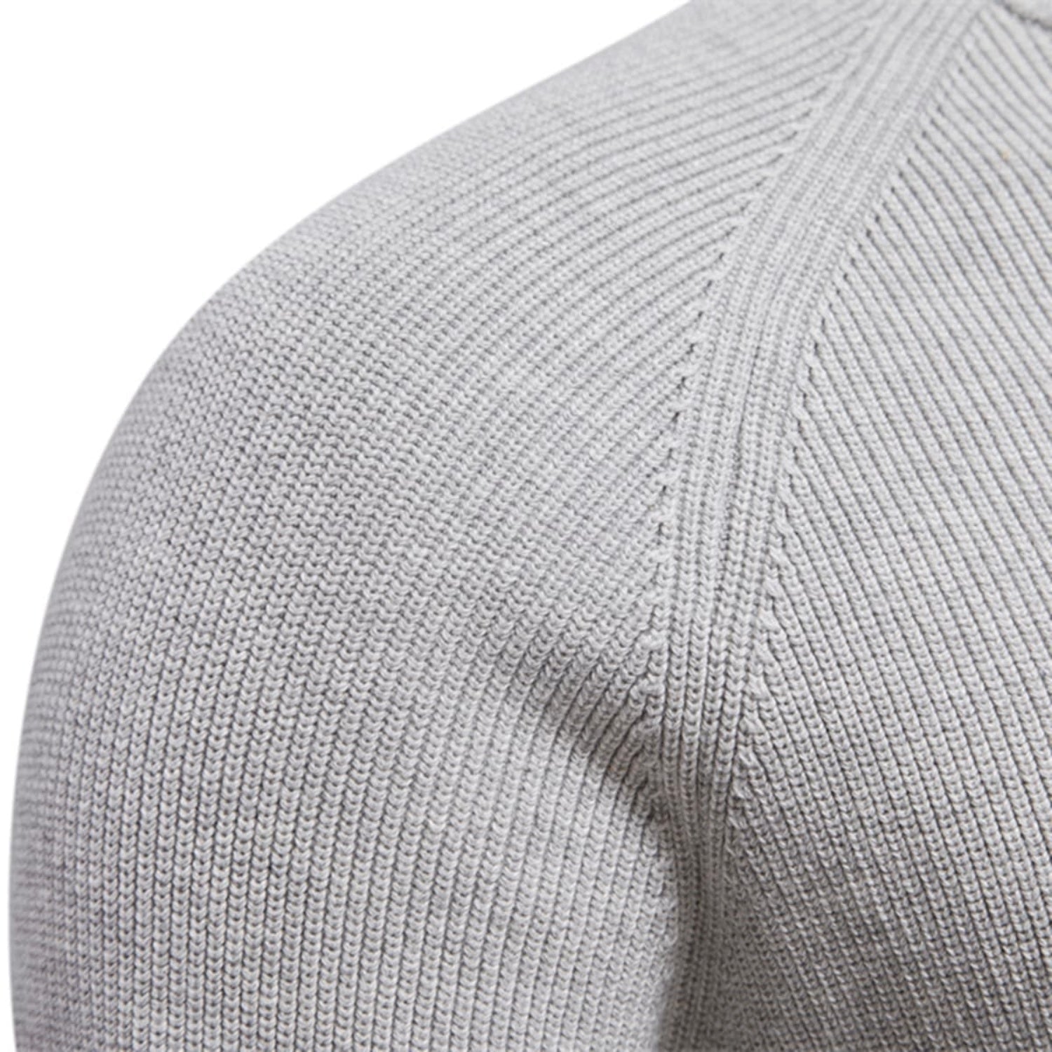 Close-up of the shoulder seam and fine knit texture of the light gray quarter-zip sweater.