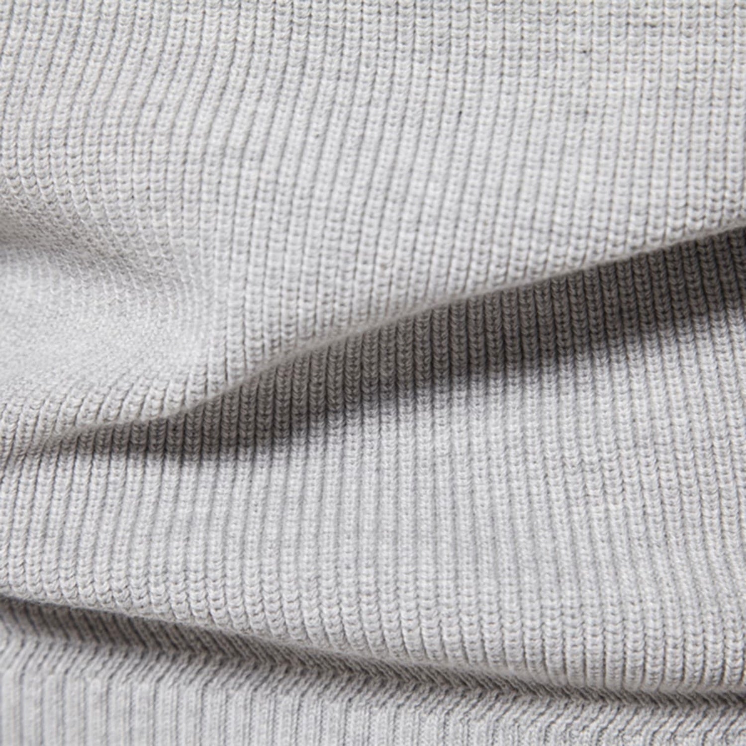 Detailed close-up of the light gray knit fabric highlighting the soft texture and weave.