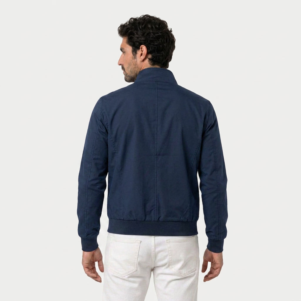 Back view of a navy bomber jacket featuring a stand collar, long sleeves, and ribbed hem.