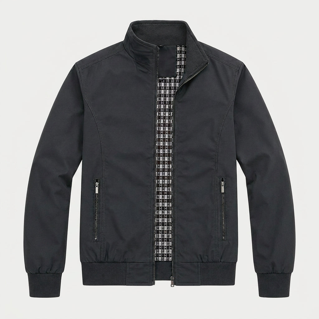 Black zip-up bomber jacket with a stand collar, plaid lining, zippered pockets, and ribbed cuffs displayed on a white background.