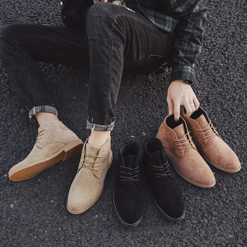 Men's suede chukka boots in tan, brown, and black with plain toes, lace-up fronts, and low block heels on asphalt.