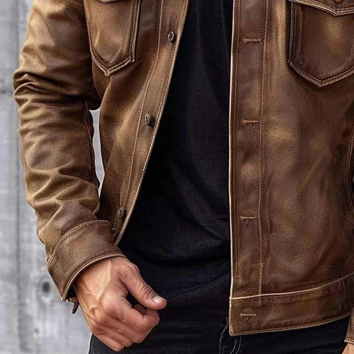 Brown vintage leather trucker jacket with a classic collar, button-up front, and functional chest flap pockets.