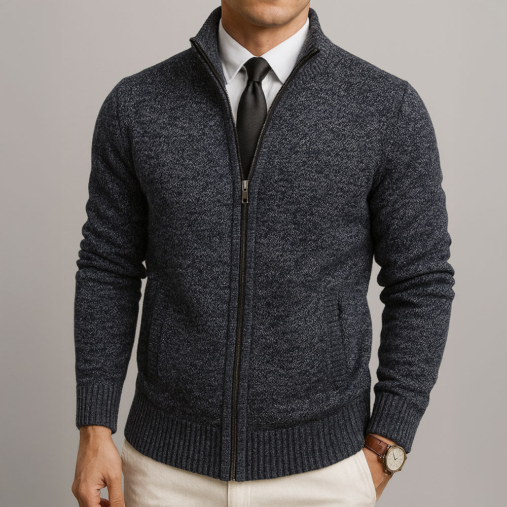 Navy blue textured zip-front cardigan with a structured collar, ribbed cuffs, and hem worn over a shirt and tie.