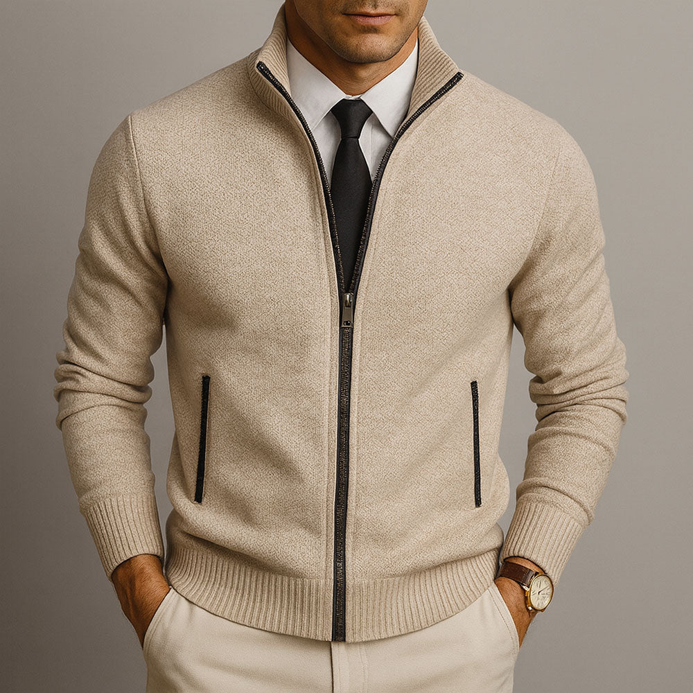 Beige textured zip-front cardigan with a structured ribbed collar, worn over a white dress shirt and black tie.