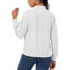 White lightweight bomber jacket in water-resistant polyester with a zip sleeve pocket and ribbed trim, worn with jeans.