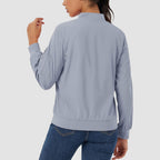 Light blue lightweight bomber jacket with a ribbed collar, zip sleeve pocket, and smooth, water-resistant finish.