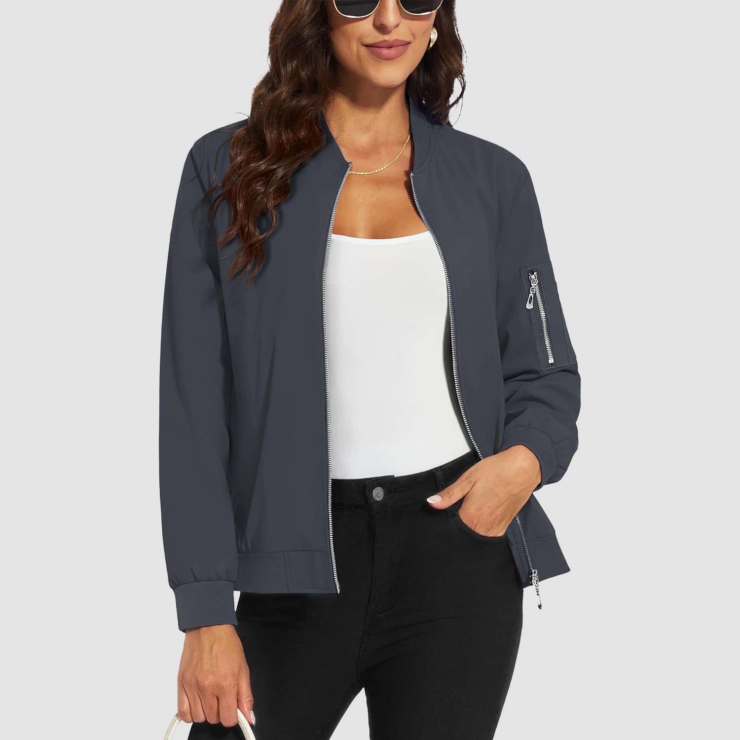 Charcoal grey lightweight bomber jacket in water-resistant polyester with a zip sleeve pocket and ribbed trim.