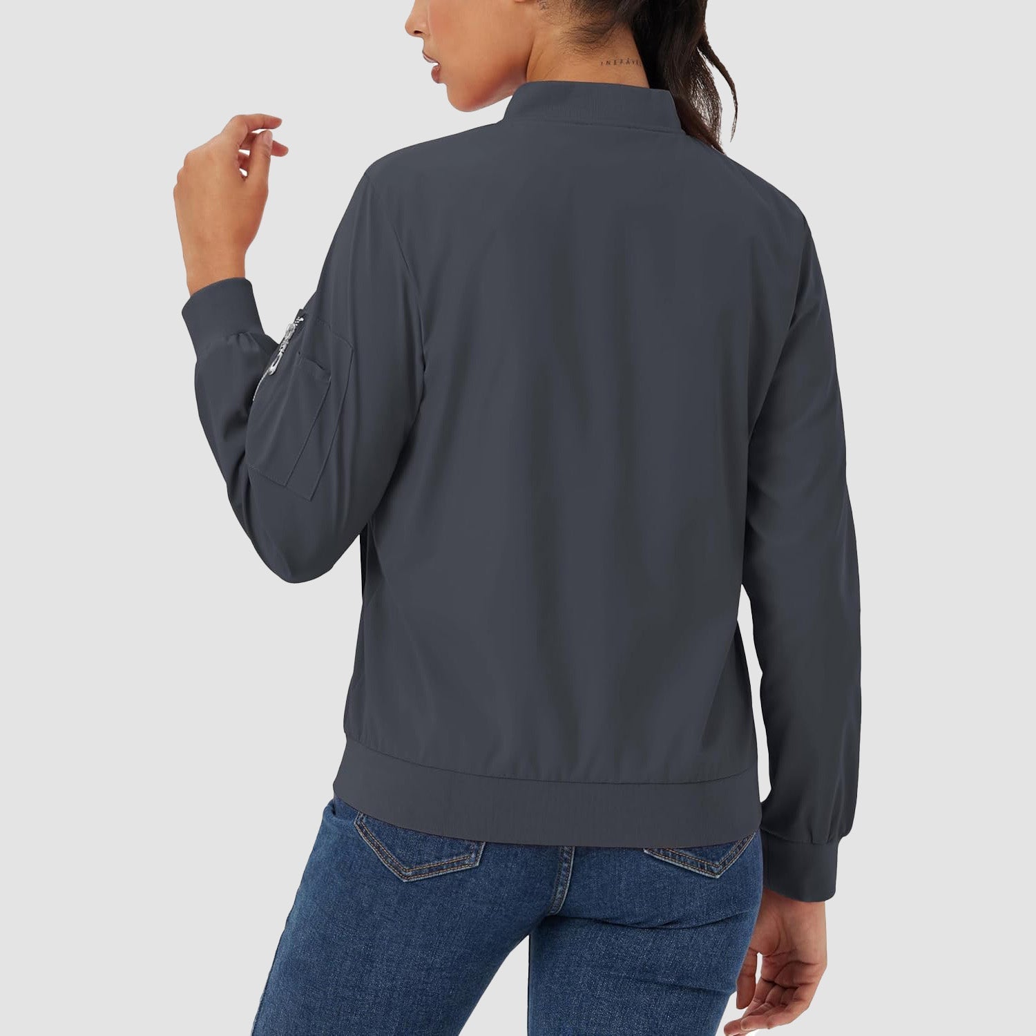 Charcoal grey lightweight bomber jacket with a zip sleeve pocket, ribbed trim, and a smooth, water-resistant finish.