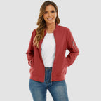 Red lightweight bomber jacket in water-resistant polyester with a zip sleeve pocket, ribbed trim, and front zip closure.