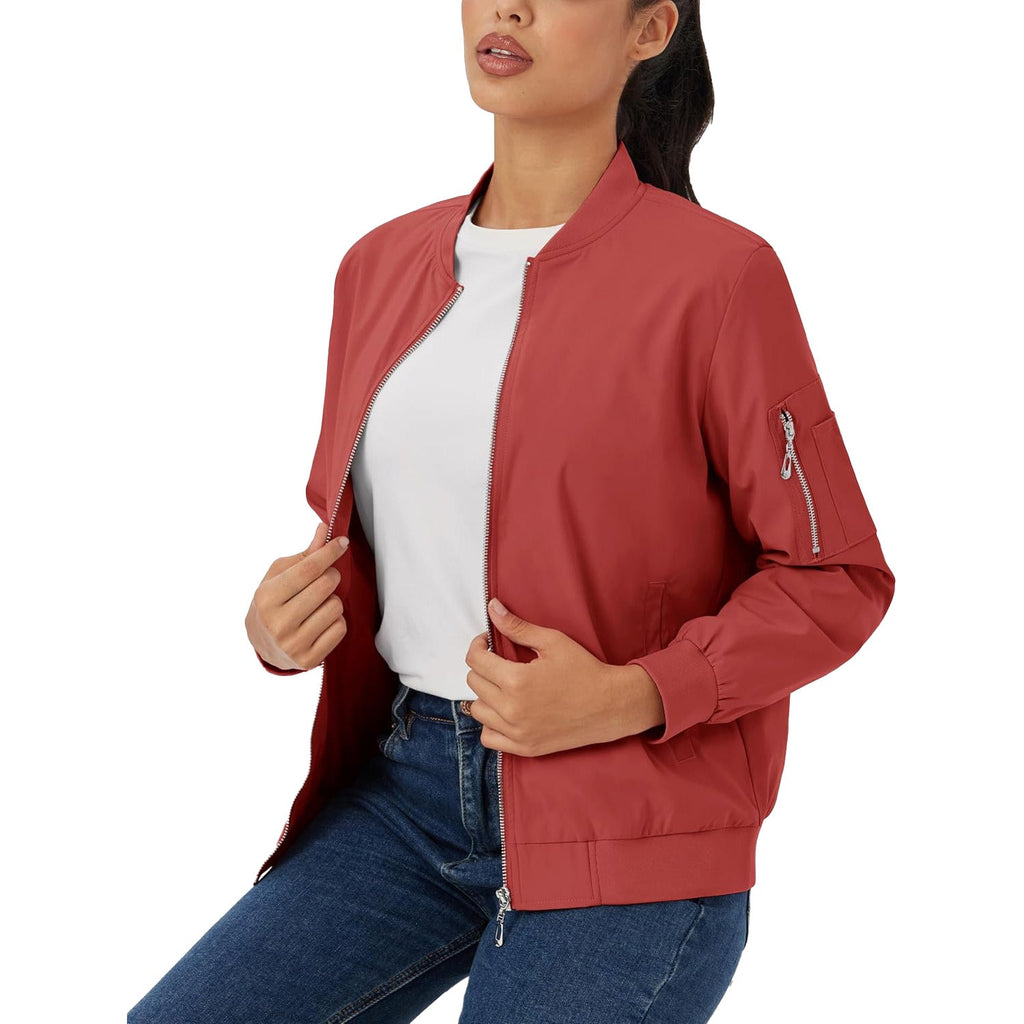 Red lightweight bomber jacket in water-resistant polyester with a zip sleeve pocket, ribbed trim, and silver hardware.