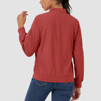 Red lightweight bomber jacket in water-resistant polyester with a zip sleeve pocket, ribbed trim, and a classic fit.