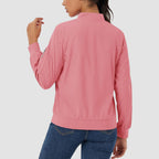 Dusty pink lightweight bomber jacket in water-resistant polyester with a zip sleeve pocket and ribbed trim.