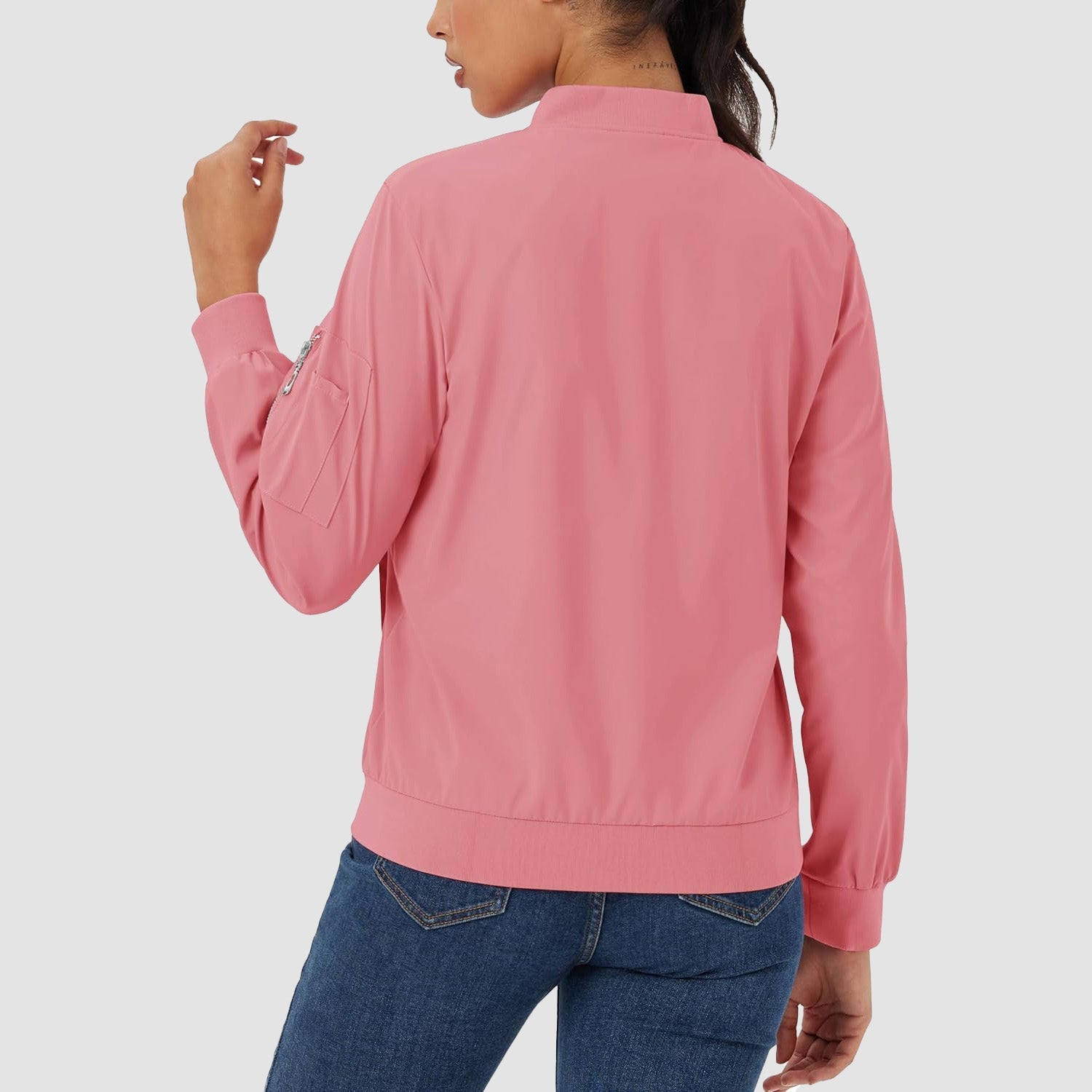 Dusty pink lightweight bomber jacket in water-resistant polyester with a zip sleeve pocket and ribbed trim.