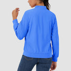 Bright blue lightweight bomber jacket with ribbed trim and a zip sleeve pocket, worn over dark denim jeans.