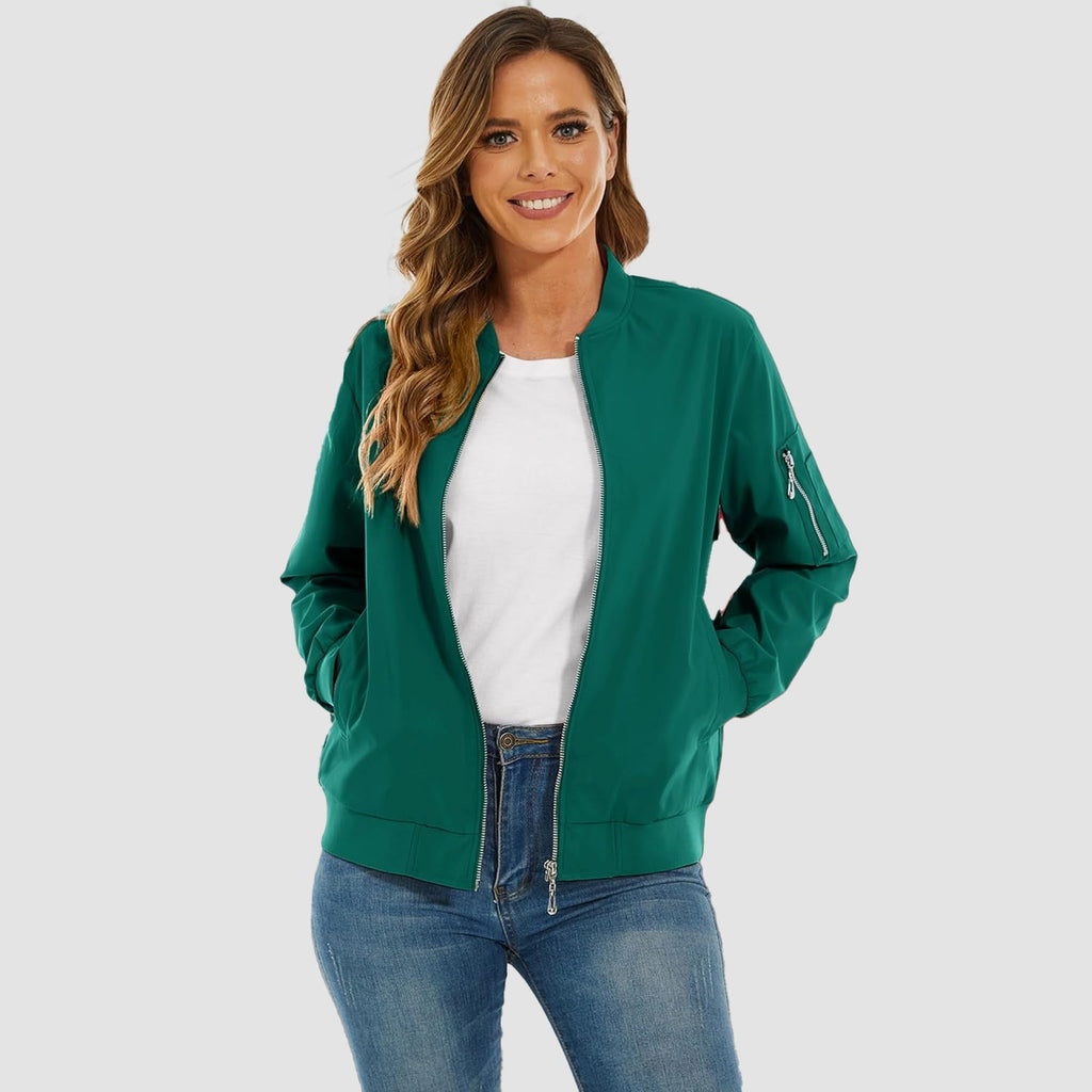 Emerald green lightweight bomber jacket with a zip-up front, ribbed trim, and utility sleeve pocket over jeans.