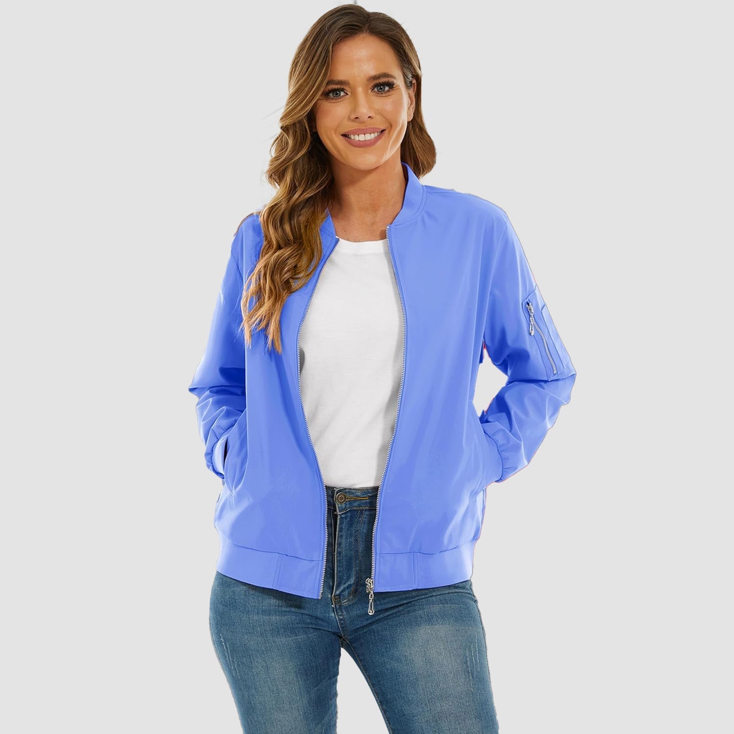Light blue lightweight bomber jacket with a zip-up front, ribbed trim, and utility sleeve pocket worn over jeans.