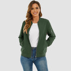 Dark green lightweight bomber jacket with a zip-up front, ribbed trim, and utility sleeve pocket worn over denim.