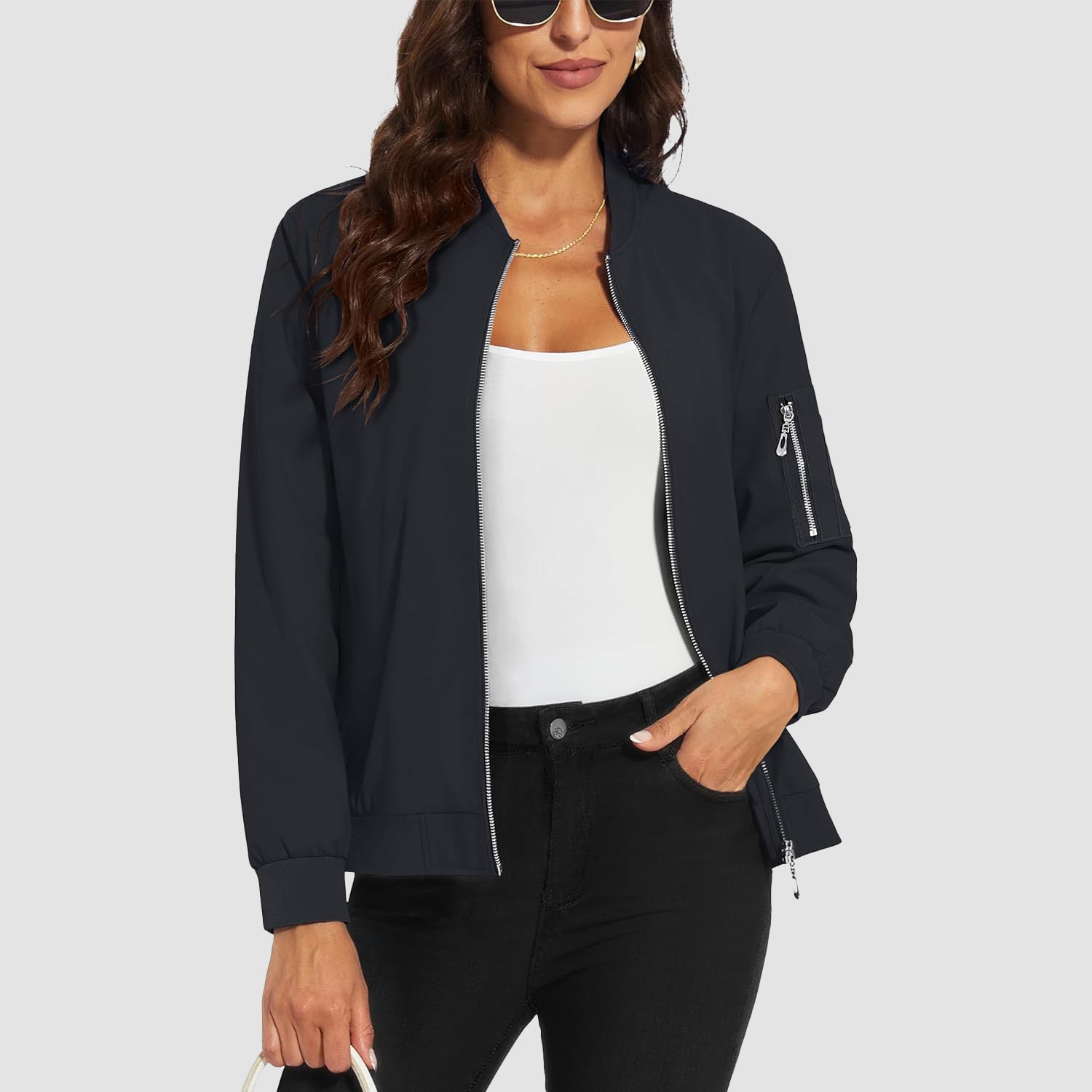 Black lightweight bomber jacket in water-resistant polyester with a zip sleeve pocket and ribbed trim.