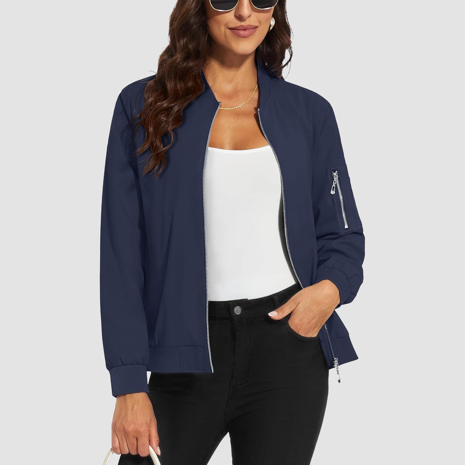 Navy blue lightweight bomber jacket with zip-up front, ribbed trim, and utility sleeve pocket.