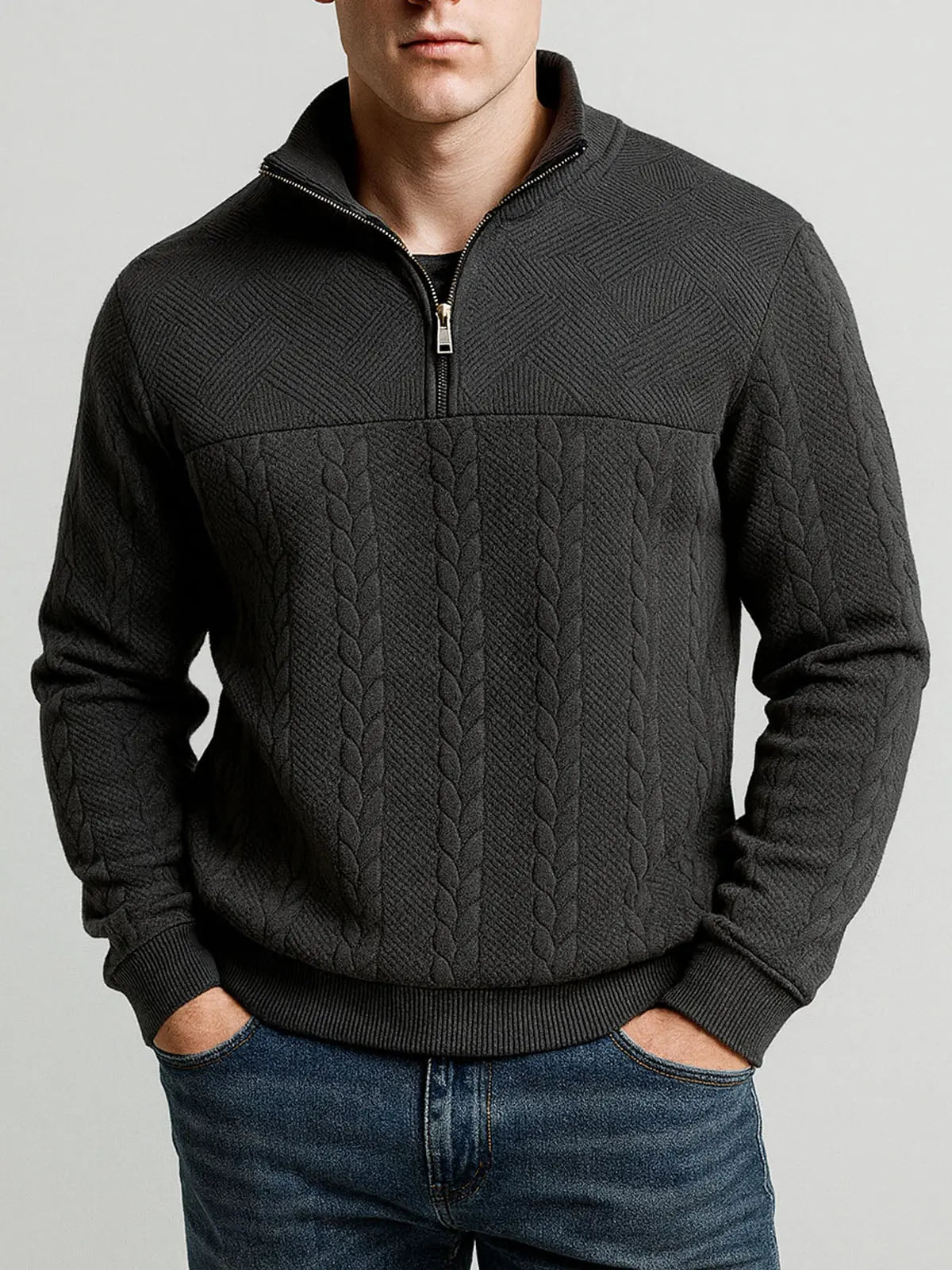 Black textured quarter-zip knit pullover with a stand collar and ribbed cuffs, worn with blue jeans for a smart casual look.