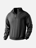 Black textured quarter-zip knit pullover with a stand collar, ribbed cuffs, and long sleeves displayed on a white background.
