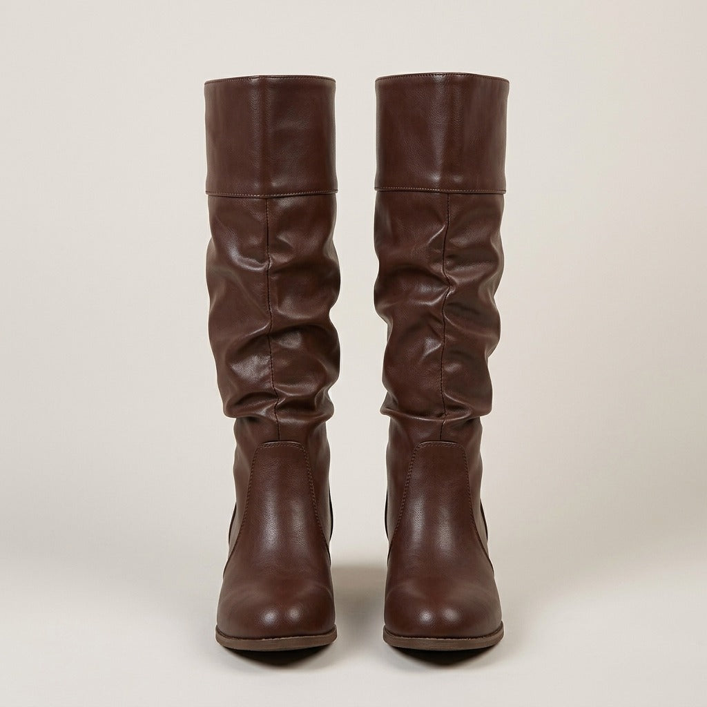 Dark brown knee-high riding boots with a slouchy shaft, cuffed top, and low stacked heel in a smooth leather-look finish.