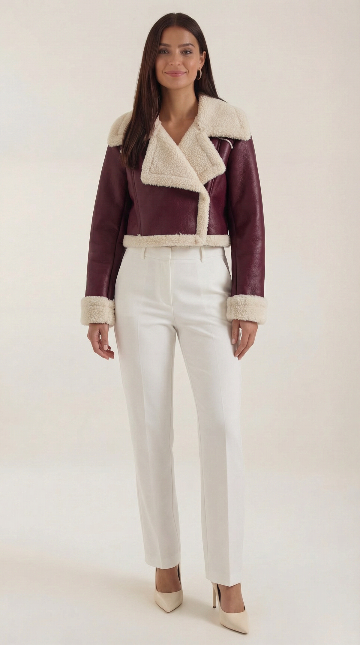Burgundy leather aviator jacket with plush cream shearling trim, featuring a cropped fit and zip-up front.