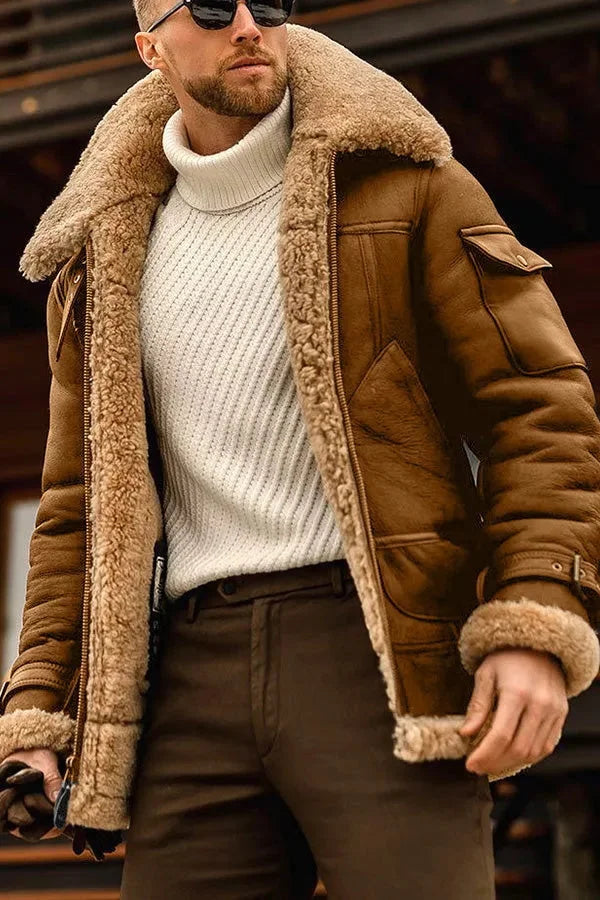 Brown leather aviator jacket with a plush shearling collar, padded lining, and flap pockets worn over a white turtleneck.
