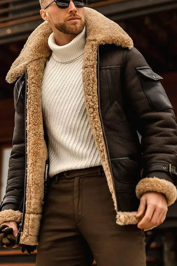 Brown leather aviator jacket with a plush shearling collar, padded lining, and flap pockets worn over a white turtleneck.