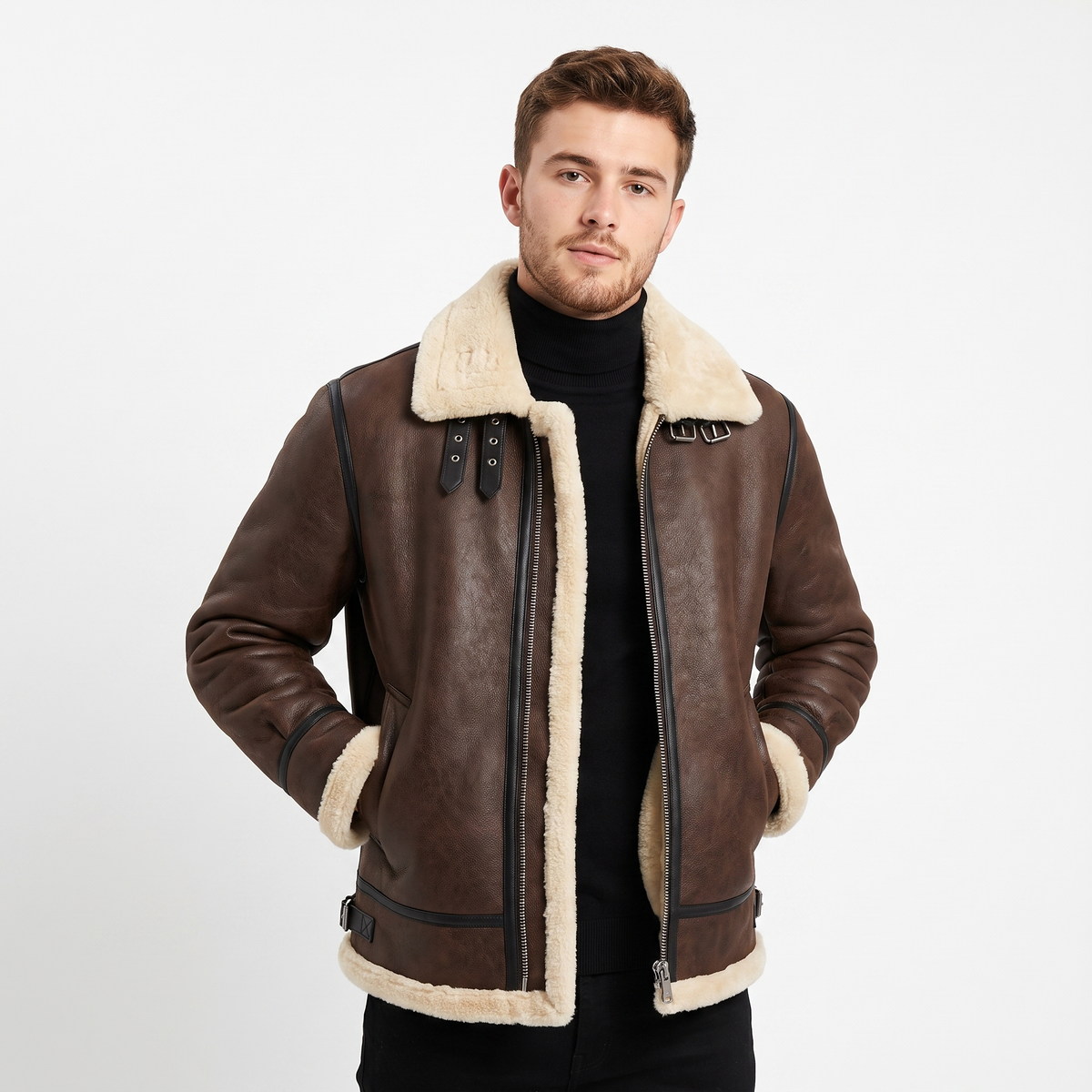 Brown leather aviator jacket with cream shearling lining, asymmetric zip closure, and buckle strap details.