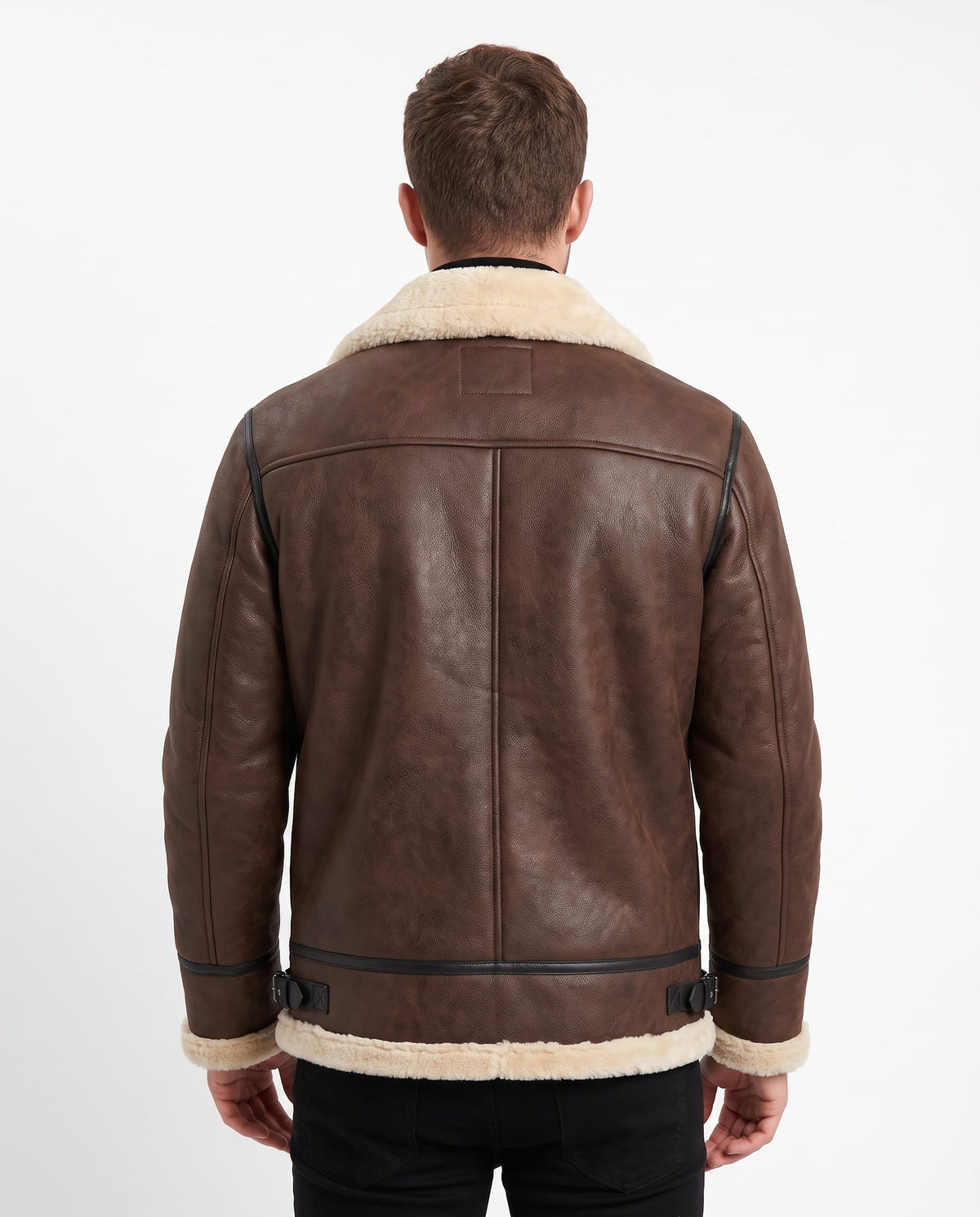 Brown leather aviator jacket with cream shearling trim, back seam detailing, and adjustable side buckle straps.