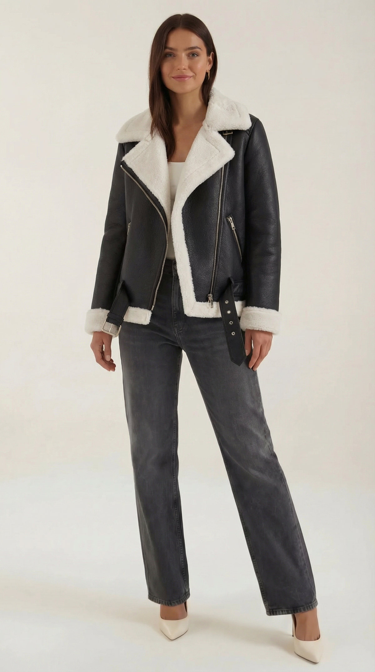 Black and white leather aviator jacket with white shearling trim, diagonal zip front, and adjustable belted hem.