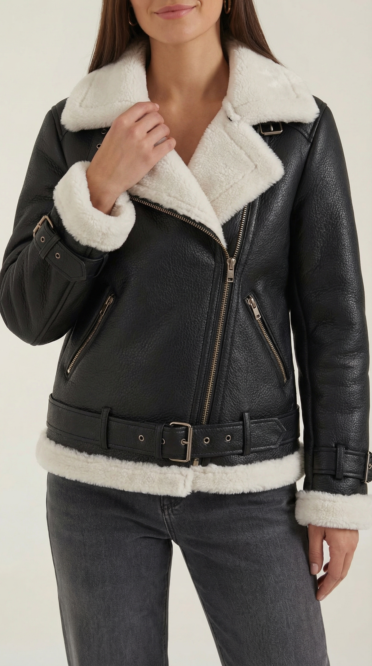 Black and white leather aviator jacket with white shearling trim, diagonal zip front, and an adjustable belted hem.