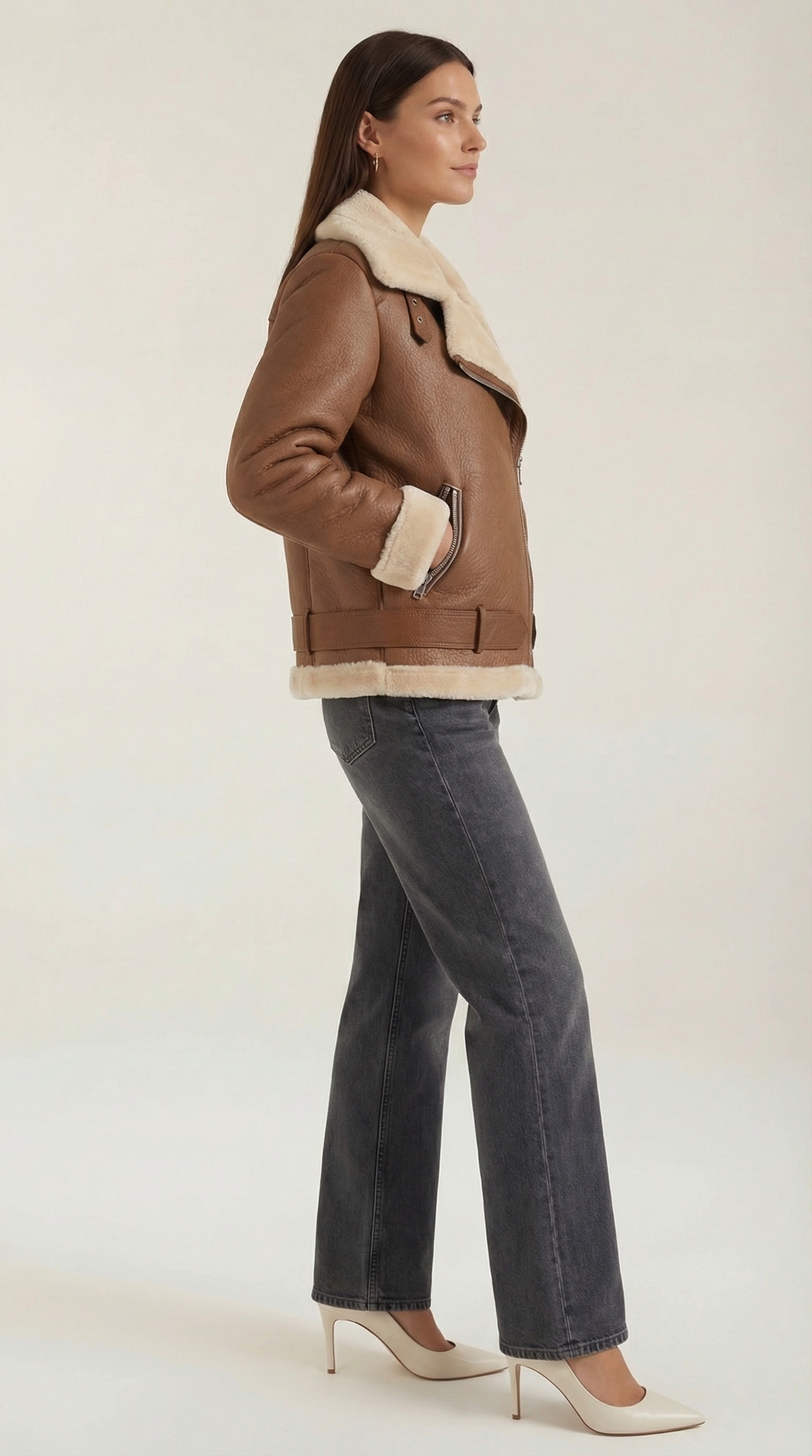 Brown leather aviator jacket with cream shearling trim, diagonal zip front, and adjustable belted hem.