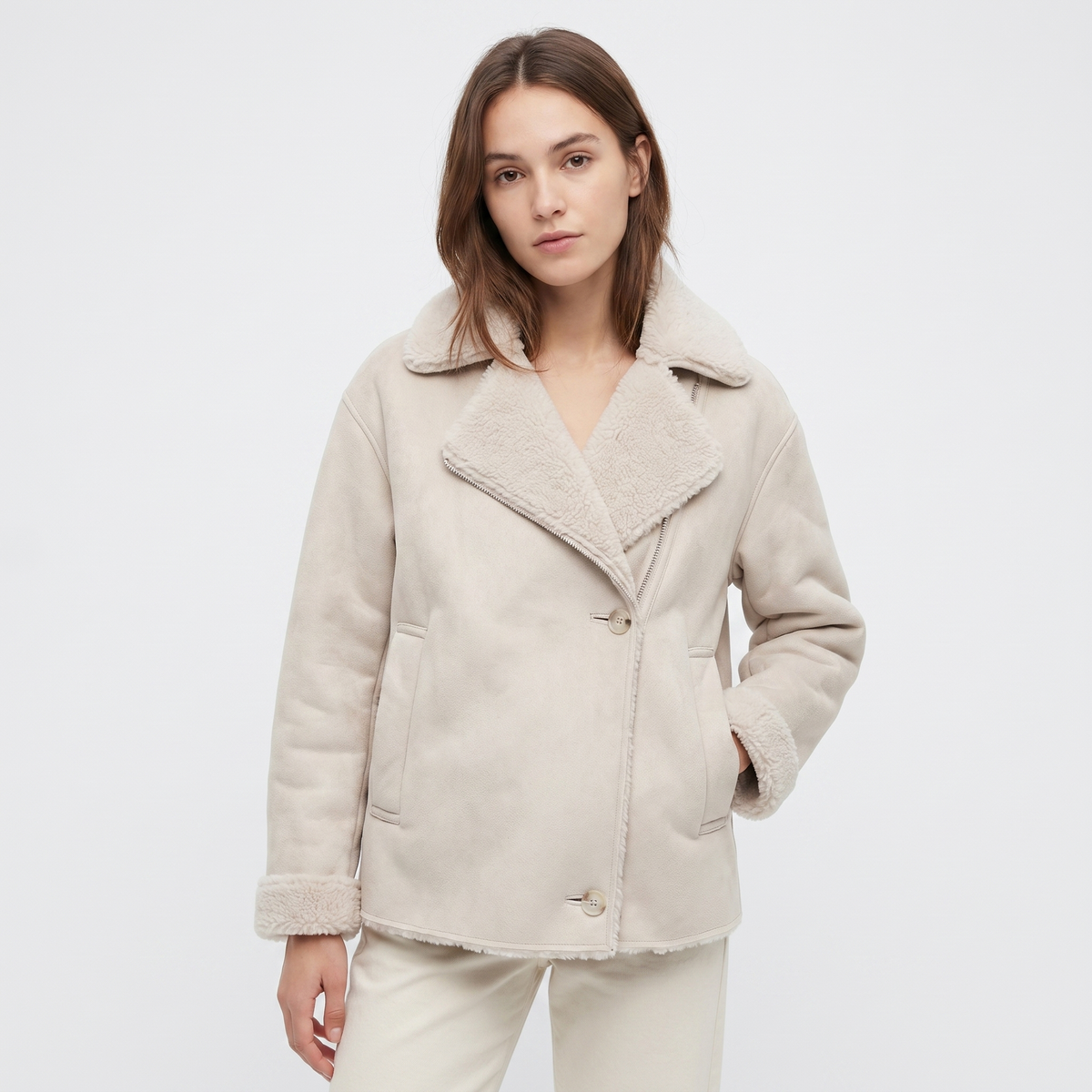 Oversized cream leather aviator jacket with a plush sherpa collar, wide lapels, and single-button fastening.