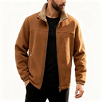 Tan polar fleece jacket with a plush sherpa-lined stand collar, zip front, and elastic cuffs worn over a black shirt.