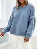 Blue oversized crew-neck sweater in soft knit with white contrast whipstitch detailing along the sleeves.