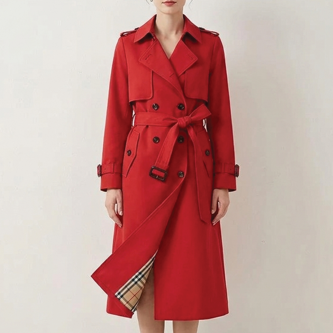 Red longline double-breasted trench coat in polyester twill with a belted waist, buckled cuffs, and checked inner lining.