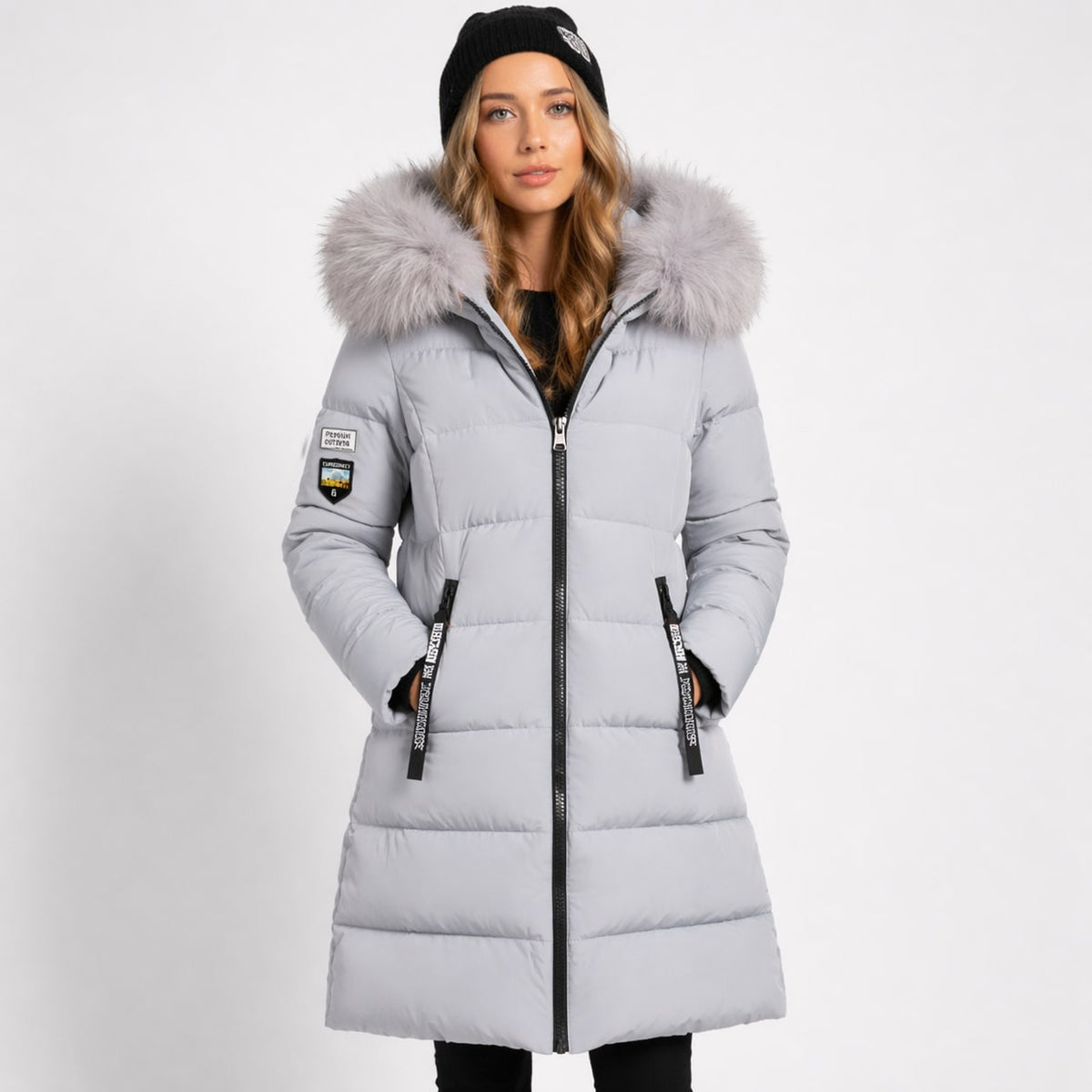 Light gray longline quilted parka with a faux-fur trimmed hood, two-way zip, and zip hand pockets.