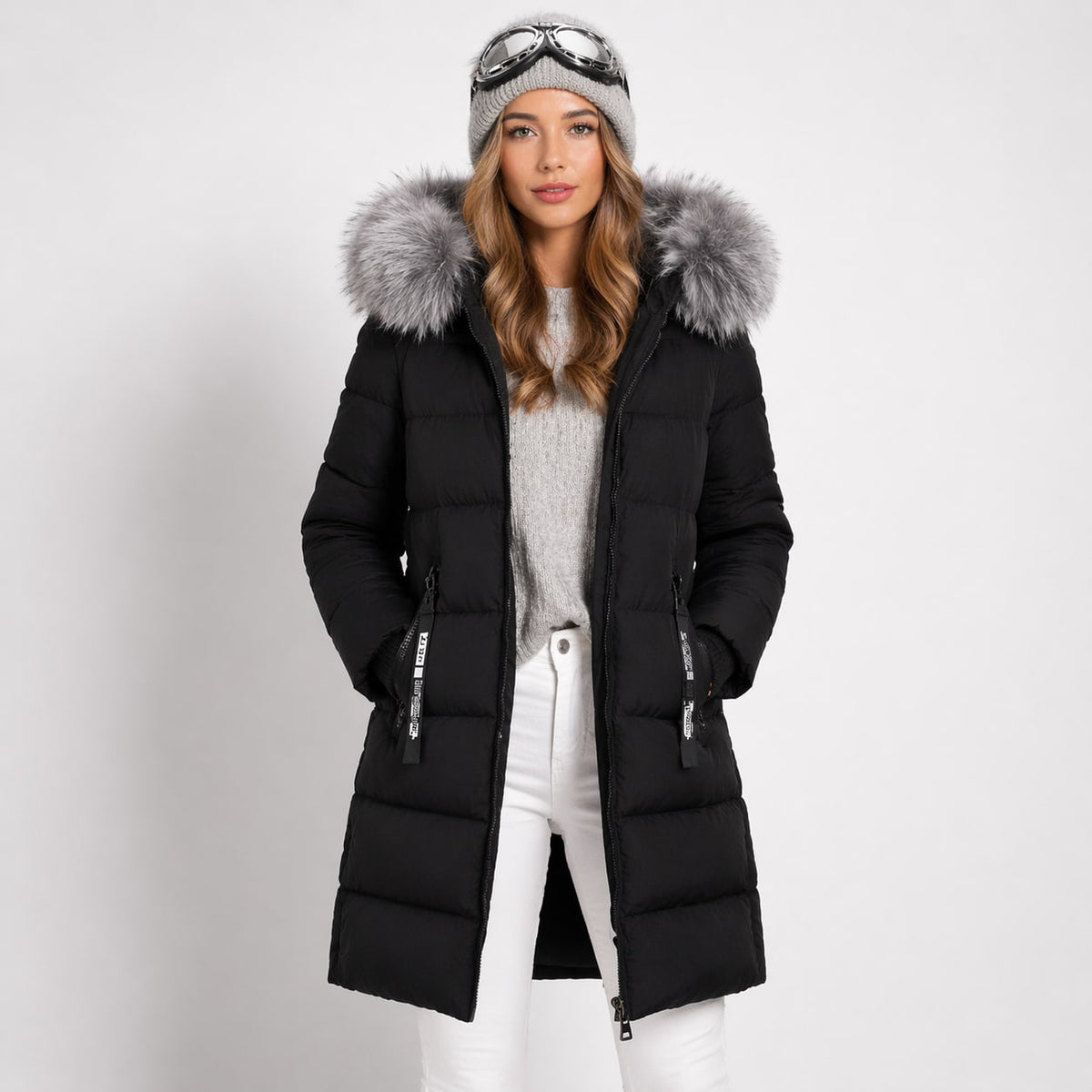 Black longline quilted parka with horizontal channels, two-way zip, and a faux-fur trimmed hood against a white background.